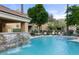 Exterior view of a community pool with waterfall feature and lounge chairs at 7887 N 16Th St # 226, Phoenix, AZ 85020