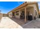 A spacious covered patio complements this home's hardscaped backyard with views of mature desert landscaping at 7930 W Wescott Dr, Glendale, AZ 85308