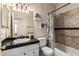 Bathroom featuring a vanity with black countertop, floral shower curtain, and decorative accents at 7930 W Wescott Dr, Glendale, AZ 85308