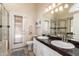 Bright bathroom features granite countertops, double sinks, and glass enclosed shower at 7930 W Wescott Dr, Glendale, AZ 85308