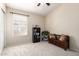 Versatile bonus room featuring carpet, neutral walls and built-in shelving for storage and display at 7930 W Wescott Dr, Glendale, AZ 85308