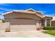 Charming single-story home with a tile roof, manicured lawn, and a two-car garage on a sunny day at 7930 W Wescott Dr, Glendale, AZ 85308