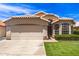 Charming single-story home with a tile roof, manicured lawn, and a two-car garage on a sunny day at 7930 W Wescott Dr, Glendale, AZ 85308