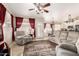 Comfortable living room with neutral color scheme, plush seating, ceiling fan, and direct access to the kitchen at 7930 W Wescott Dr, Glendale, AZ 85308