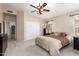 Relaxing main bedroom with a ceiling fan, neutral carpet, and closet with mirrored doors at 7930 W Wescott Dr, Glendale, AZ 85308