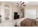 Bright main bedroom features neutral carpet, a large window, and an attached bath at 7930 W Wescott Dr, Glendale, AZ 85308