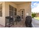 Cozy covered patio with tile flooring, outdoor seating, and a view of the landscaped backyard at 7930 W Wescott Dr, Glendale, AZ 85308