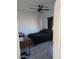 Cozy bedroom features ceiling fan, dark walls, gray floors, and a window at 8678 S John Jacob Astor Ave, Casa Grande, AZ 85193