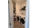 Convenient laundry room with washer, dryer, storage shelves, and natural light at 8678 S John Jacob Astor Ave, Casa Grande, AZ 85193