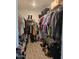 Walk-in closet, neatly organized with hanging clothes, shoes, and storage shelves at 8678 S John Jacob Astor Ave, Casa Grande, AZ 85193