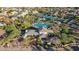 A community aerial view featuring pools, tennis courts, clubhouse, ponds and desert landscaping at 9265 N 115Th St, Scottsdale, AZ 85259
