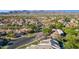 Aerial view of residential neighborhood, community, and mountain views on a clear sunny day at 9265 N 115Th St, Scottsdale, AZ 85259