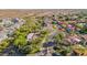 An aerial view of the neighborhood showing the home surrounded by desert landscape at 9265 N 115Th St, Scottsdale, AZ 85259