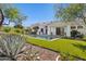 The backyard has an infinity pool, turf, desert landscaping and view of the back of the home at 9265 N 115Th St, Scottsdale, AZ 85259