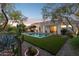 The landscaped backyard has a built in barbeque, pool and a covered patio area at 9265 N 115Th St, Scottsdale, AZ 85259