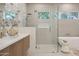 Beautiful bathroom boasts walk-in shower, soaking tub, dual sink vanity, and clerestory windows at 9265 N 115Th St, Scottsdale, AZ 85259