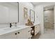 Beautiful dual sink bathroom vanity with marble countertop, decor, and framed mirrors and tiled shower at 9265 N 115Th St, Scottsdale, AZ 85259