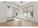 Light-filled bedroom features hardwood floors, a window overlooking greenery, and closet with mirrored sliding doors at 9265 N 115Th St, Scottsdale, AZ 85259