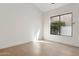 Bedroom with hard wood floors and a window is lit by sun and decorated with outdoor flora at 9265 N 115Th St, Scottsdale, AZ 85259