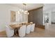 Bright dining room features a decorative light fixture, a rustic wood table and soft white chairs at 9265 N 115Th St, Scottsdale, AZ 85259