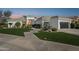 Stunning single-story home with lush green lawn and manicured landscaping at dusk at 9265 N 115Th St, Scottsdale, AZ 85259