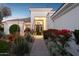 Charming home featuring a manicured walkway leading to the front entrance at dusk at 9265 N 115Th St, Scottsdale, AZ 85259