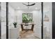 Bright home office featuring a large window, modern furnishings, and a tranquil atmosphere at 9265 N 115Th St, Scottsdale, AZ 85259