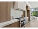 Gourmet kitchen featuring stainless steel appliances, custom cabinets, and quartz countertops at 9265 N 115Th St, Scottsdale, AZ 85259