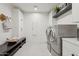 Laundry room featuring a bench, shelving, front-load washer/dryer and storage at 9265 N 115Th St, Scottsdale, AZ 85259