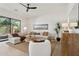 Cozy living room with neutral tones, a plush sectional, and a view of the tranquil outdoor scenery at 9265 N 115Th St, Scottsdale, AZ 85259