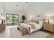 Serene main bedroom with large windows, hardwood floors and a backyard pool view at 9265 N 115Th St, Scottsdale, AZ 85259