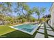The infinity pool has mature trees, desert landscaping, artificial turf and stone walkways at 9265 N 115Th St, Scottsdale, AZ 85259