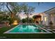 Backyard pool surrounded by artificial turf and accented with natural desert foliage and trees at 9265 N 115Th St, Scottsdale, AZ 85259