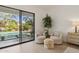 Cozy sitting area with comfortable chairs and an outdoor pool view at 9265 N 115Th St, Scottsdale, AZ 85259