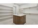 Spacious walk-in closet with custom shelving, a central island, and clean, modern design at 9265 N 115Th St, Scottsdale, AZ 85259