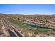 Expansive aerial view of a luxury homes, a golf course, and a shimmering pond at 9432 N Longfeather --, Fountain Hills, AZ 85268