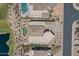 Aerial view of residential homes featuring pools, landscaping, and desert surroundings near a pond at 9432 N Longfeather --, Fountain Hills, AZ 85268