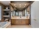 Bathroom with a double vanity, large mirror, and a soaking tub at 9432 N Longfeather --, Fountain Hills, AZ 85268