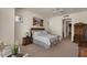 Cozy bedroom featuring neutral tones, a ceiling fan, and an en-suite bathroom entrance at 9432 N Longfeather --, Fountain Hills, AZ 85268