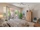 Comfortable bedroom featuring neutral decor, a ceiling fan, patio access and plentiful sunlight at 9432 N Longfeather --, Fountain Hills, AZ 85268
