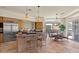 Open kitchen and dining area with large windows, tiled floors, and island cooktop, perfect for entertaining at 9432 N Longfeather --, Fountain Hills, AZ 85268