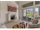 Cozy living room featuring a fireplace, comfortable seating, and large sliding doors to view the well-manicured backyard at 9432 N Longfeather --, Fountain Hills, AZ 85268