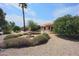 View of house with tiled roof and lush backyard landscaping with fountain at 9813 W Mcrae Way, Peoria, AZ 85382