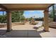 Covered patio overlooking backyard fountain and desert landscaping at 9813 W Mcrae Way, Peoria, AZ 85382