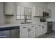 Bright kitchen featuring white cabinets, stainless steel appliances, and a view to the outside at 9813 W Mcrae Way, Peoria, AZ 85382