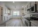 Modern kitchen with stainless steel appliances, white cabinets, and an open layout at 9813 W Mcrae Way, Peoria, AZ 85382