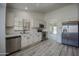 Open kitchen featuring stainless steel appliances, plenty of counter space, and sleek cabinets at 9813 W Mcrae Way, Peoria, AZ 85382