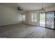 Large Living room with tile floors, ceiling fan, and patio door to the backyard at 9813 W Mcrae Way, Peoria, AZ 85382