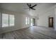 Bright living room featuring tile floors, ceiling fan, and access to outdoor space at 9813 W Mcrae Way, Peoria, AZ 85382