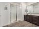 Bright bathroom featuring a sink vanity and large glass enclosed shower with built-in bench at 9922 E Thunderbolt Ave, Mesa, AZ 85212